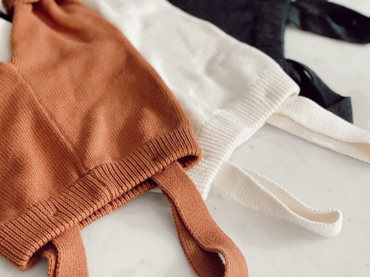 Folded knitted overalls in three colours