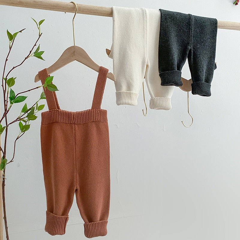 Brown knitted overalls with tops on a rail
