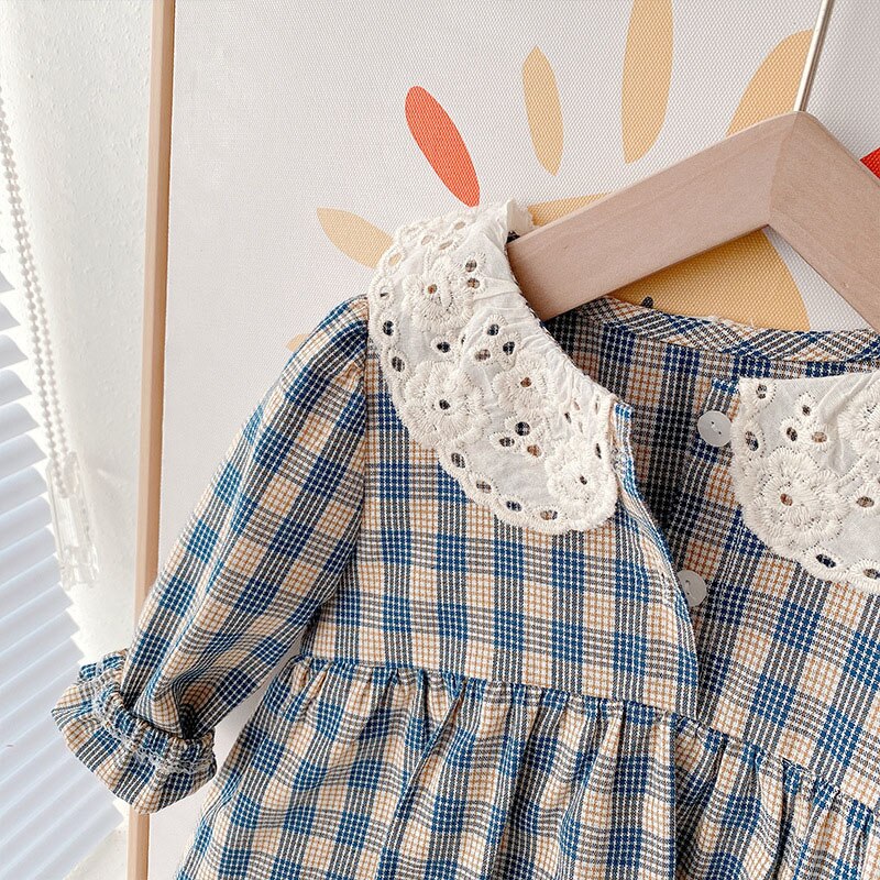 Close-up of crochet lace collar on plaid dress