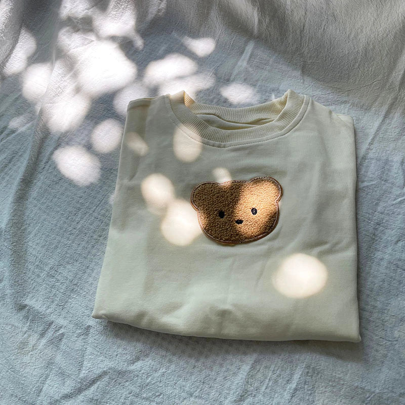 Folded mint bear patch sweatshirt