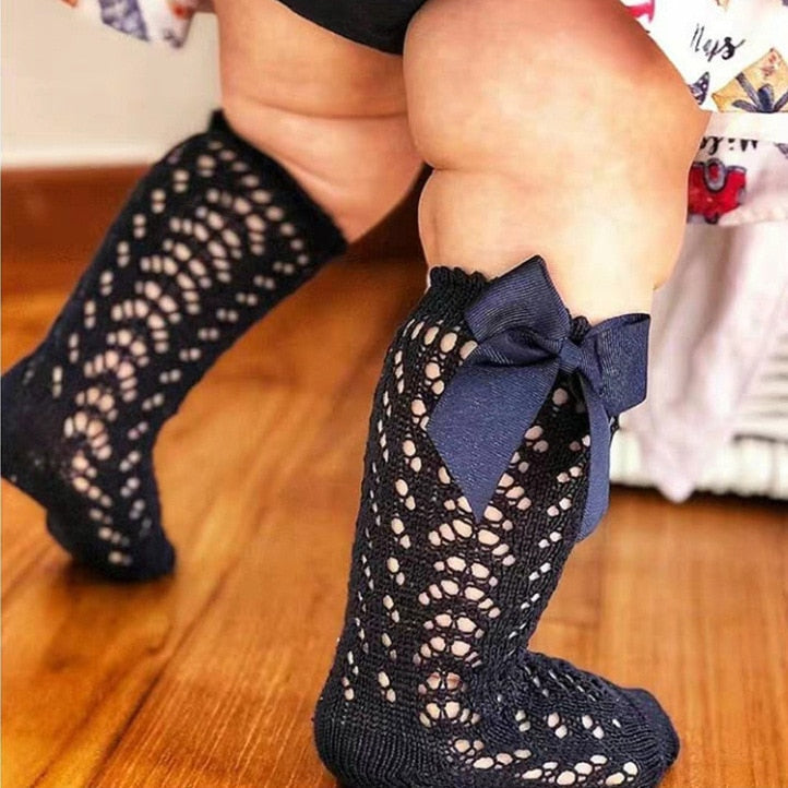Toddler wearing navy openwork bow socks