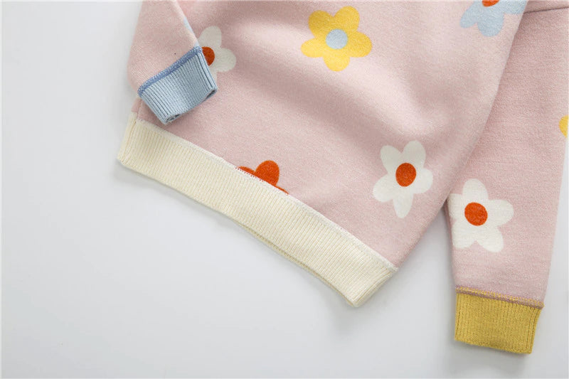 Close-up of cuff on pink daisy sweater