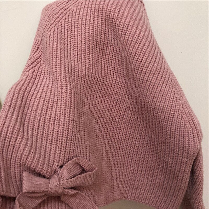Close-up of bow tie on pink knit sweater