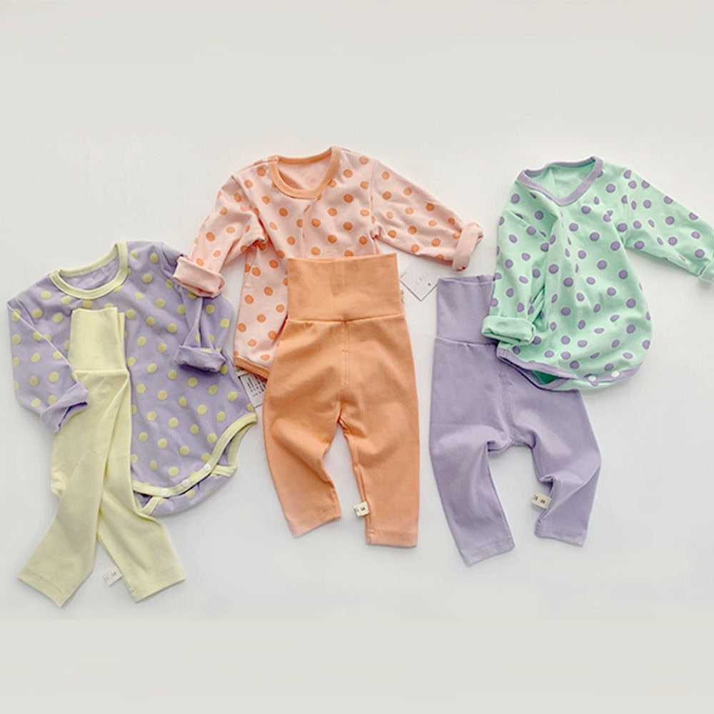 Polka dot bodysuit and leggings sets laid flat