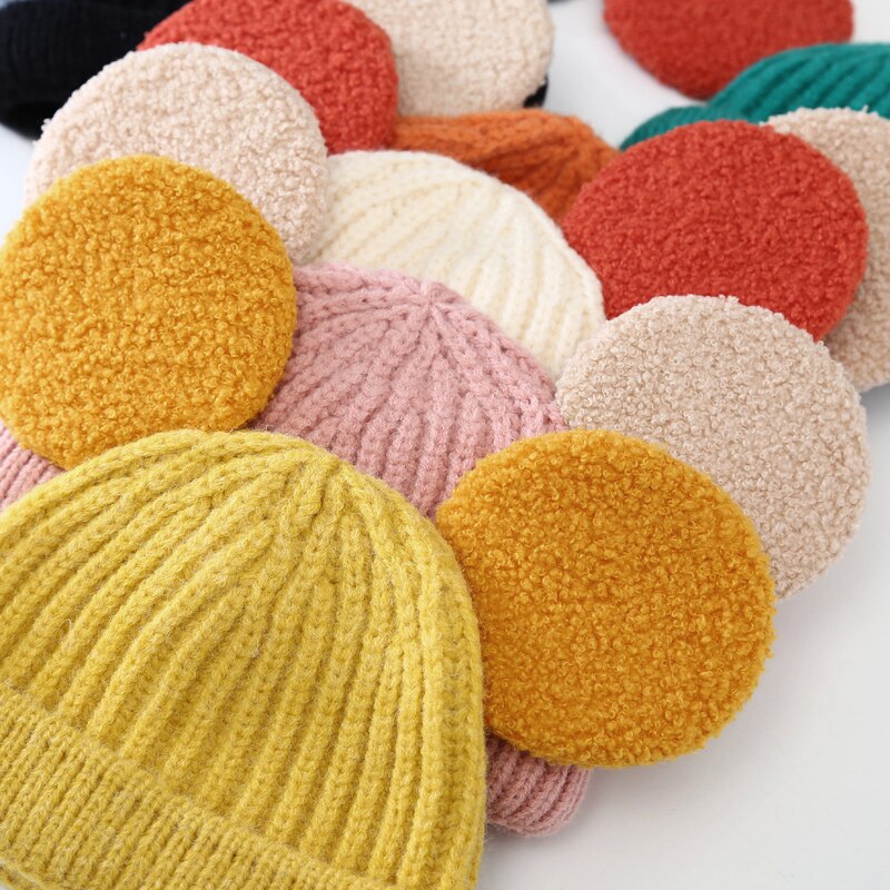 Close-up of colourful round ears beanies
