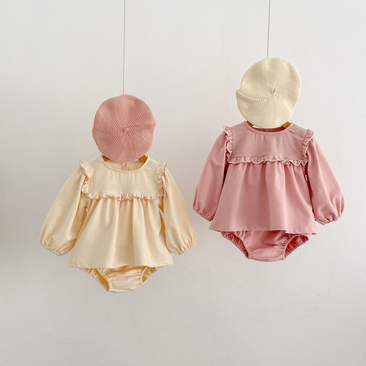 Beige and pink ruffle sets hanging with berets