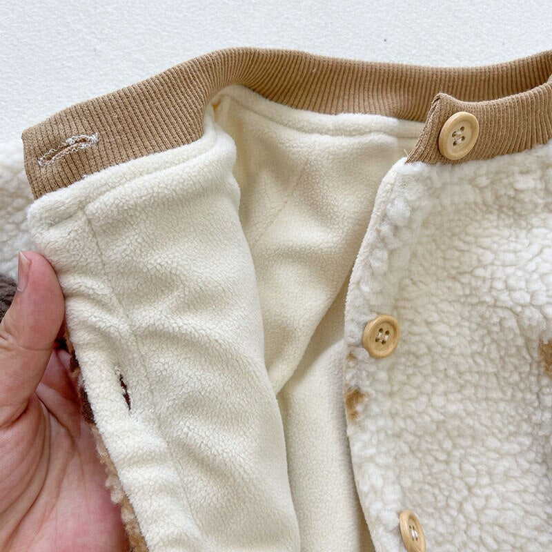 Hand showing soft lining of sherpa romper