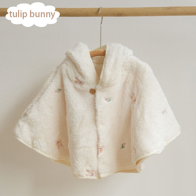 Squirrel embroidered cape on a hanger
