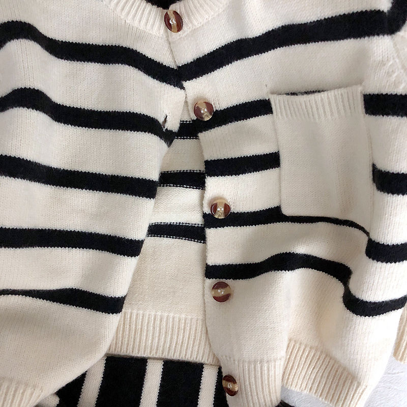 Close-up of pocket and buttons on striped cardigan