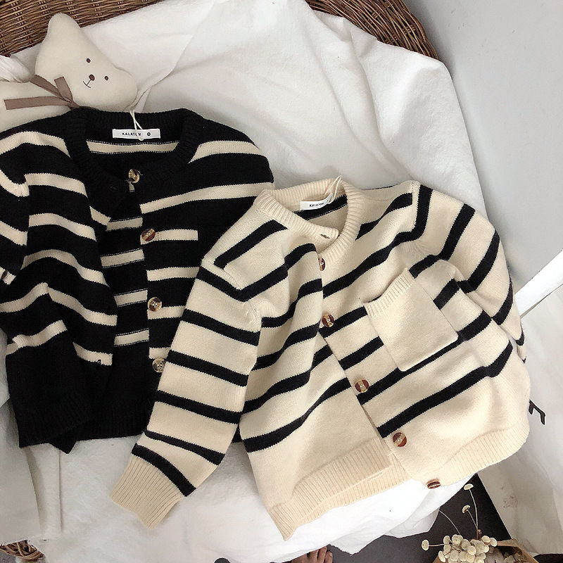 Pair of striped knit cardigans laid flat