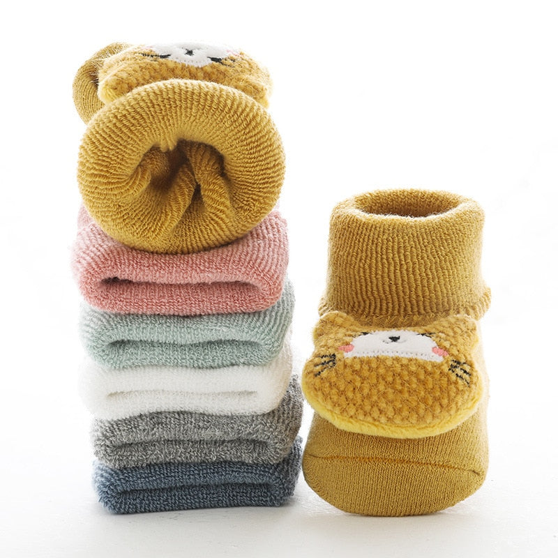 Stack of thick baby socks in assorted colours