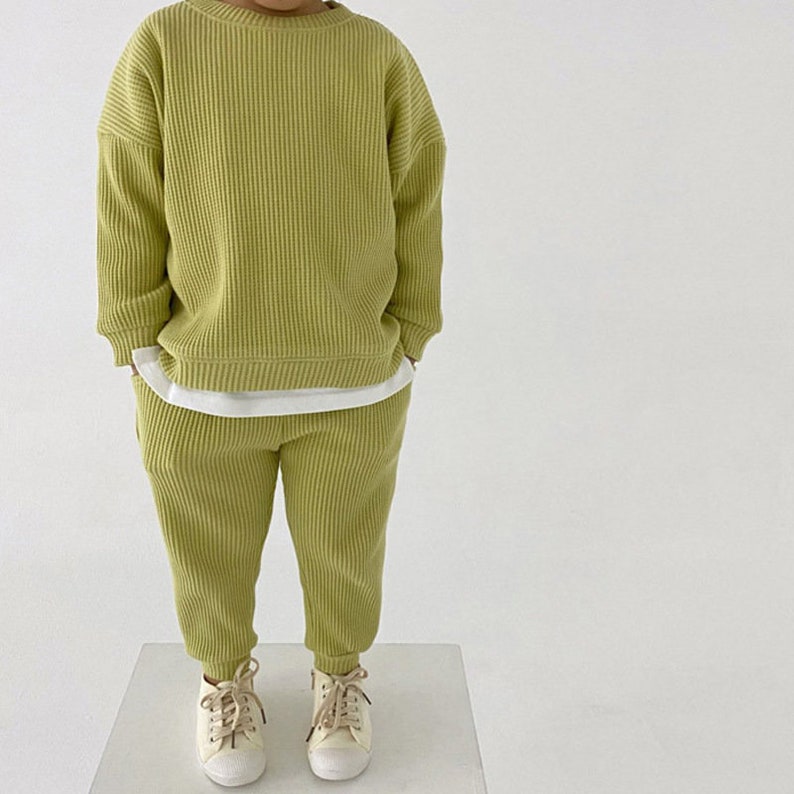 Toddler wearing green waffle tracksuit