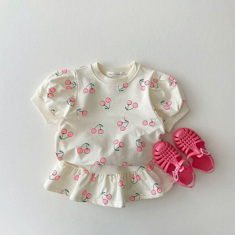 White cherry print top and skirt with pink sandals