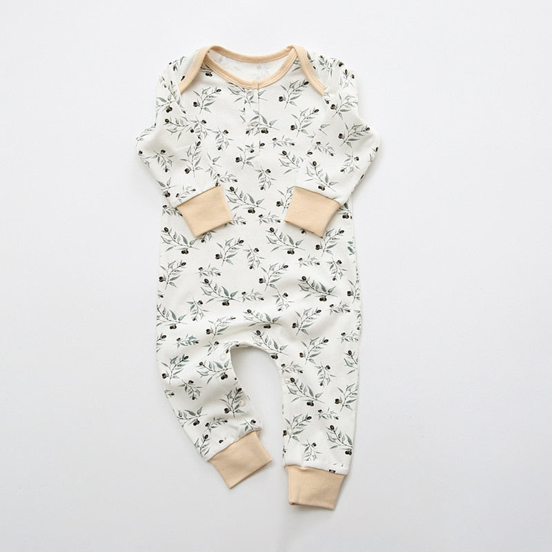 White floral print baby romper with peach cuffs
