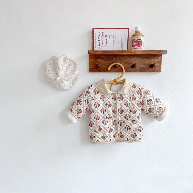 White floral jacket hanging on a shelf