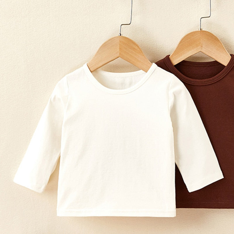 White long sleeve baby top on a hanger
