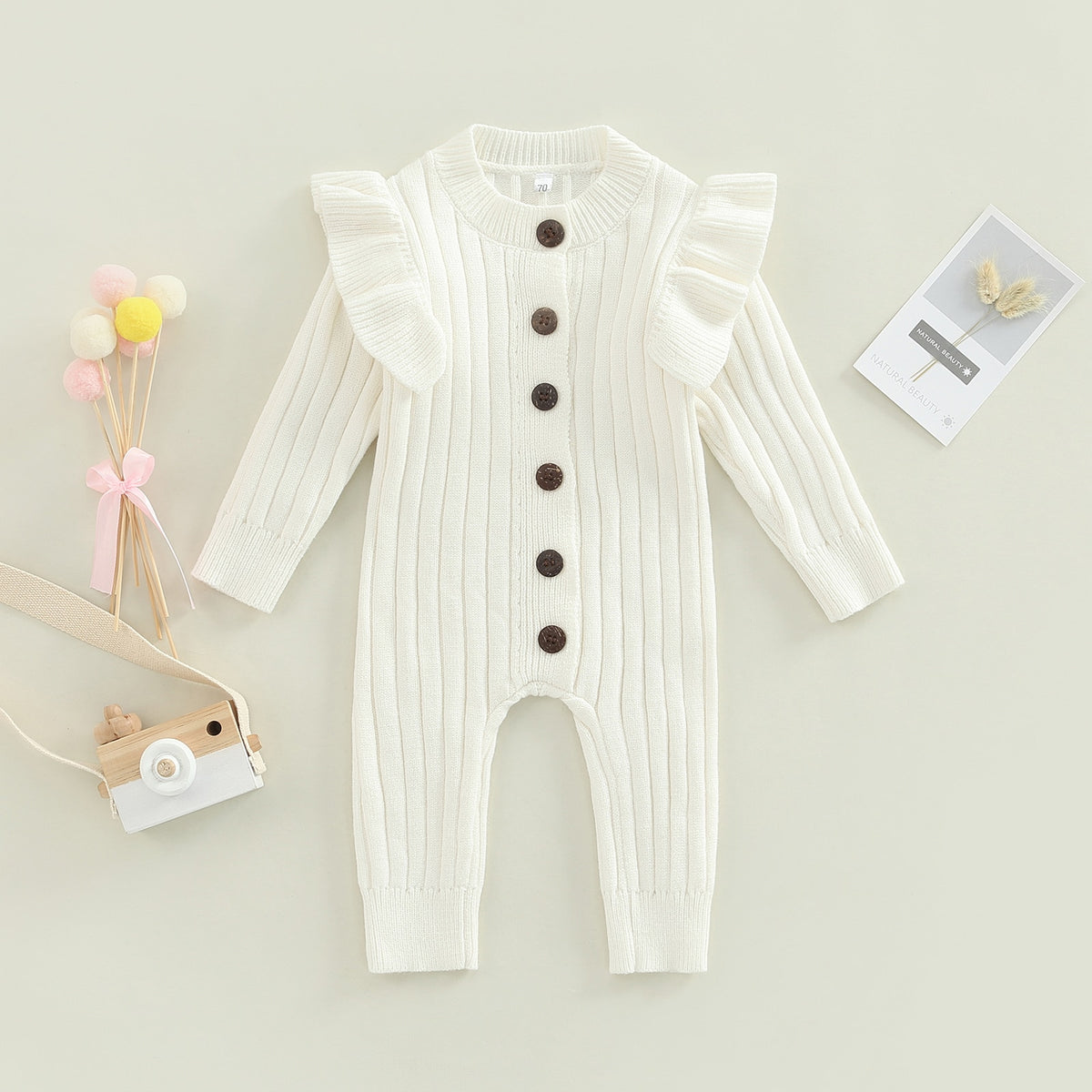 White ribbed knit jumpsuit with ruffle shoulders